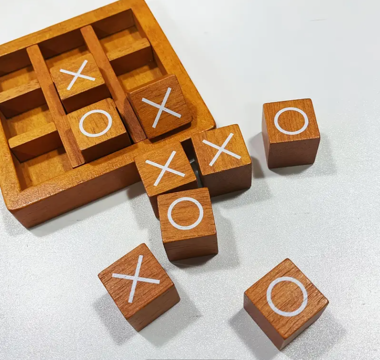 Wooden blocks with 'X' and 'O' symbols on a white background